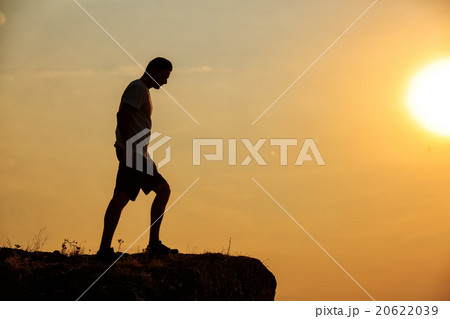 Man stands near the cross on top of mountain Man stands near the cross on top of mountain 20622039