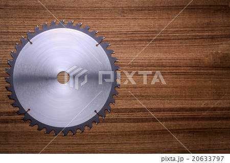 Circular saw blade on wooden background Circular saw blade on wooden background 20633797
