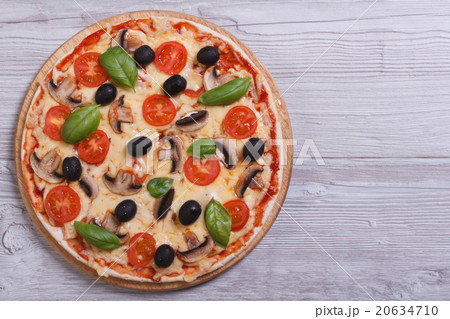Mushroom pizza with olives, tomatoes and basil Mushroom pizza with olives, tomatoes and basil 20634710