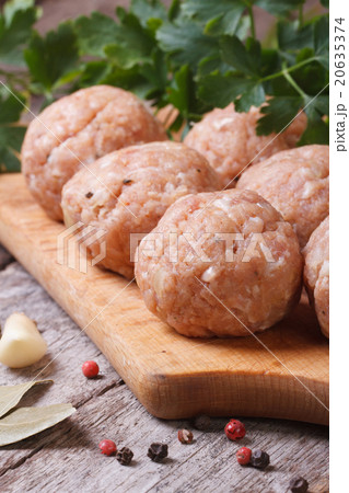 raw meatballs on a chopping board vertical raw meatballs on a chopping board vertical 20635374
