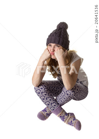 Beautiful girl in  funny cap is sitting on a floor 20641536
