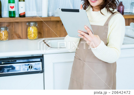 台所でタブレットPCを操作する女性の手元　白い　台所　キッチン　調理場　レシピ検索　メニュー検索 20642472
