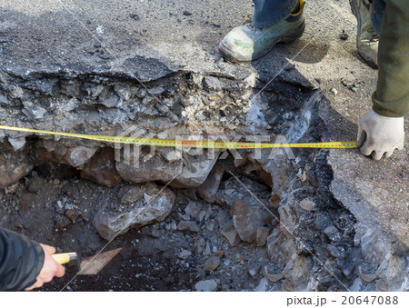 workers check a tape measure workers check a tape measure 20647088