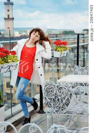 beautiful woman in a red sweater posing near the rails 20647405