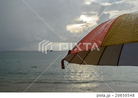 Colorful umbrella in the rain and blur beach Colorful umbrella in the rain and blur beach 20650548