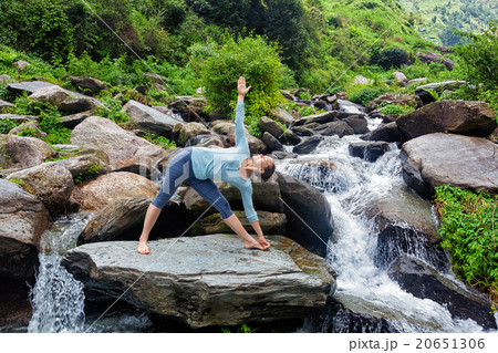 Woman doing Ashtanga Vinyasa yoga asana  outdoors 20651306