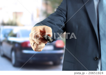 Young successful businessman offering a car key. Young successful businessman offering a car key. 20651924