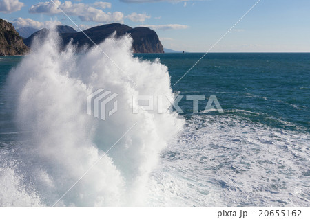 Stone breakwater with breaking waves. Stone breakwater with breaking waves. 20655162