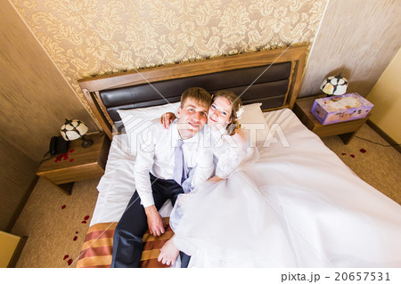 charming bride and groom in their bedroom charming bride and groom in their bedroom 20657531