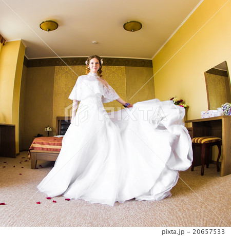 Beautiful bride in flying wedding dress in the 20657533