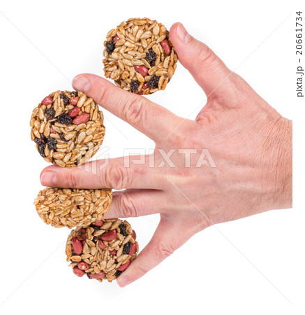 Candied roasted peanuts seeds in hand. Candied roasted peanuts seeds in hand. 20661734