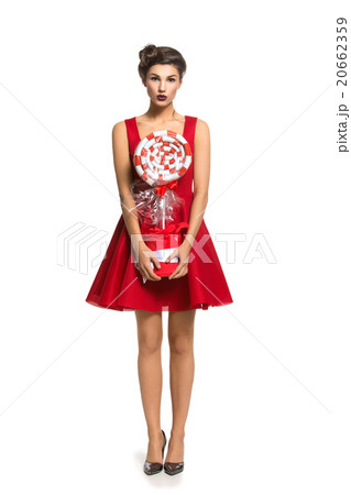Girl in red dress with big candy Girl in red dress with big candy 20662359