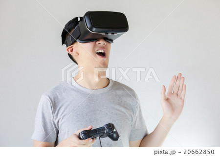 Asian man wearing VR goggle in white background 20662850