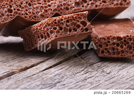 pile of porous chocolate on old wooden table 20665269