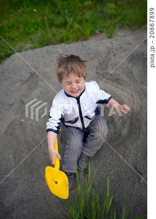 Little boy plays on heap of crushed stone 20667899