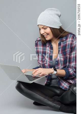 Attractive girl is using a notebook for fun Attractive girl is using a notebook for fun 20678858