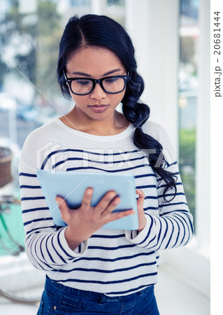 Attractive Asian woman using tablet Attractive Asian woman using tablet 20681444