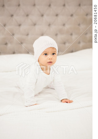 Smiling baby on bed Smiling baby on bed 20681450