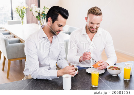 Smiling gay couple having breakfast Smiling gay couple having breakfast 20681553