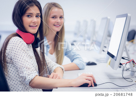 Smiling students using computer Smiling students using computer 20681748
