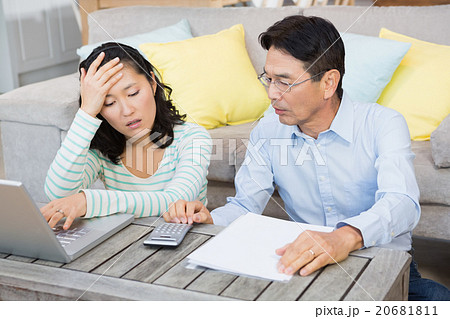 Worried couple checking bills 20681811