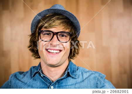 Smiling blond hipster staring at camera Smiling blond hipster staring at camera 20682001