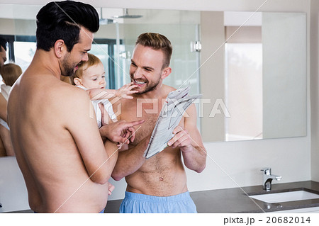 Smiling gay couple with child Smiling gay couple with child 20682014