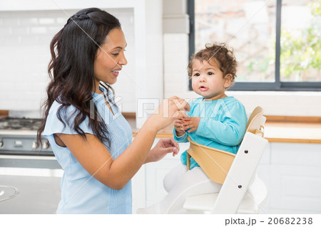 Happy brunette feeding her baby 20682238