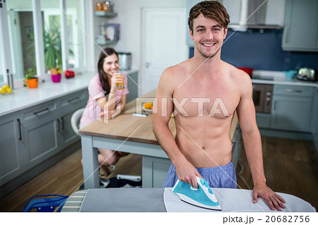 Handsome man ironing in the kitchen Handsome man ironing in the kitchen 20682756