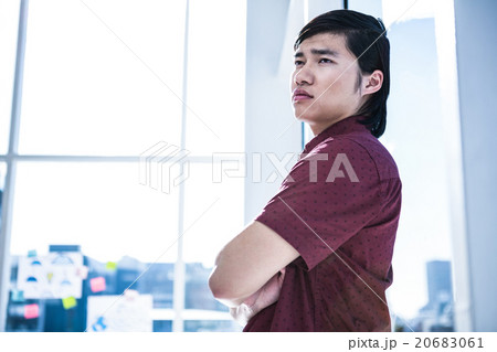 Worried creative businessman leaning on wall 20683061