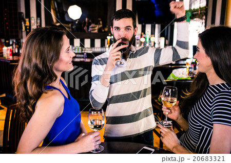 Group of friends having a glass of wine Group of friends having a glass of wine 20683321