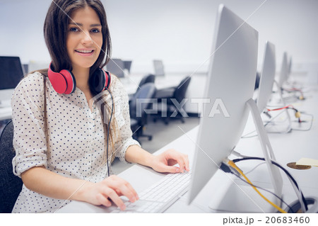 Smiling student working on computer Smiling student working on computer 20683460