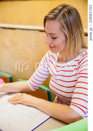 happy female student writing notes happy female student writing notes 20683702