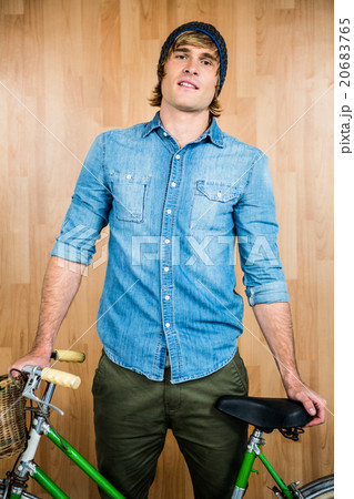 Portrait of hipster standing with bicycle Portrait of hipster standing with bicycle 20683765