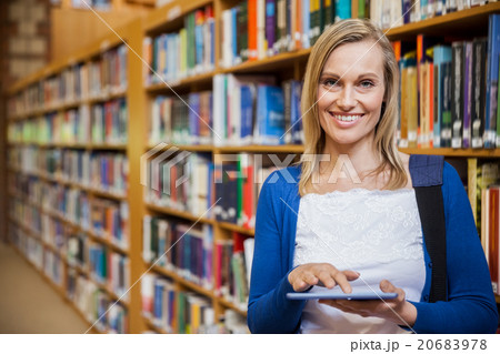 Female student using tablet in the library 20683978