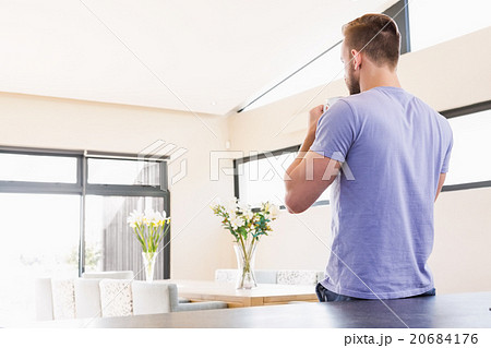 Rear view of handsome man drinking coffee Rear view of handsome man drinking coffee 20684176