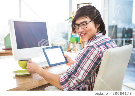 Hipster businessman using tablet 20684178