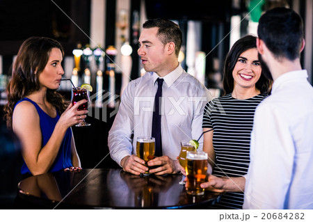 Friends talking and having a drink Friends talking and having a drink 20684282