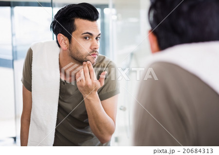 Handsome man looking in mirror Handsome man looking in mirror 20684313