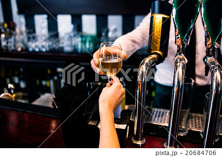 Barman giving drink to customer Barman giving drink to customer 20684706