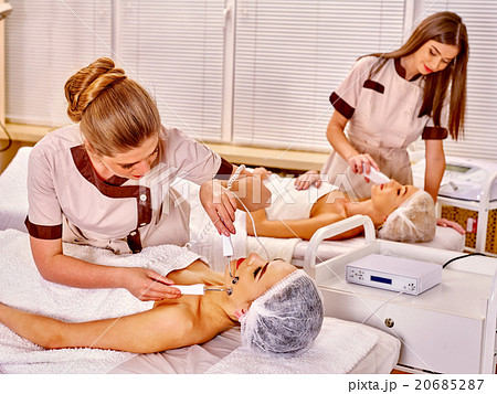 Young woman receiving electric facial massage. 20685287