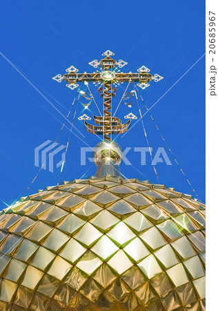 Golden orthodox cross against blue sky background Golden orthodox cross against blue sky background 20685967