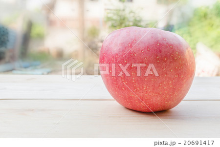 Apple placed on a wooden table 20691417