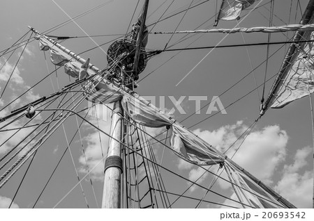 Mast with sails of an old sailing vessel, black and white photo 20693542