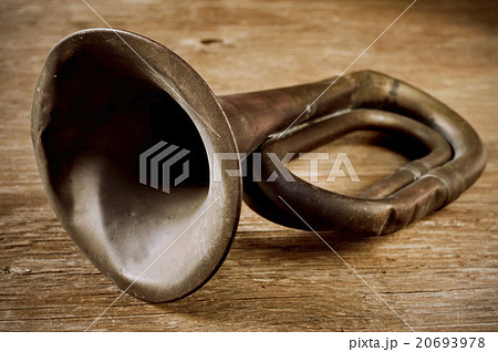 old bugle on a wooden surface old bugle on a wooden surface 20693978