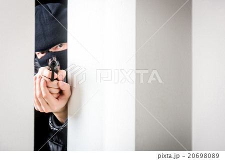 Aiming murderer with a gun 20698089