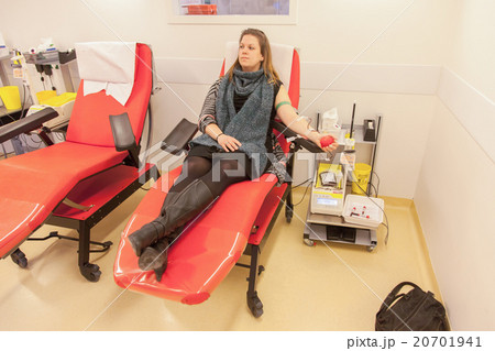 Donor in an armchair donates blood 20701941
