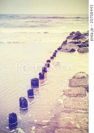 Retro old film stylized photo of a breakwater. 20706445