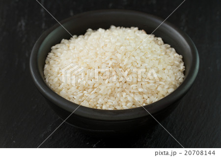 dry rice in black bowl dry rice in black bowl 20708144