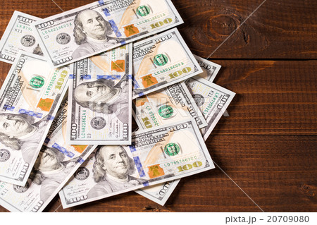 new 100 US dollars bills on wooden background new 100 US dollars bills on wooden background 20709080